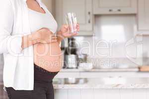 Pregnant woman drinking glass of water