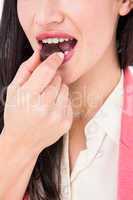 Smiling brunette eating chocolate