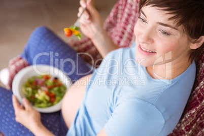 Pregnant woman eating a salad