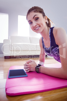 Fit woman doing plank on mat