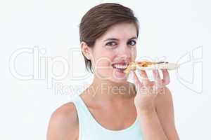 Beautiful woman eating a pizza