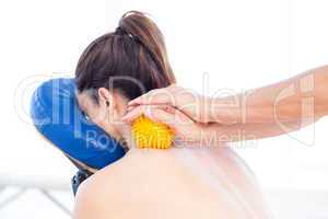 Woman having back massage with massage ball