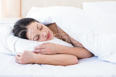 Pretty brunette sleeping on bed