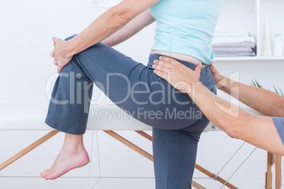 Physiotherapist examining his patient back