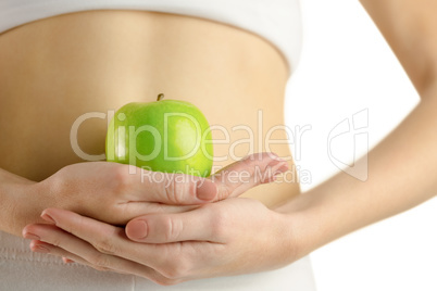 Slim woman holding green apple