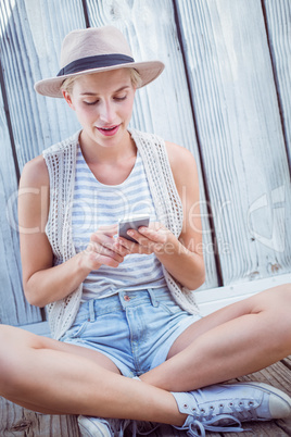 Pretty blonde woman texting with her mobile phone