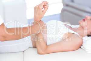 Physiotherapist examining her patients wrist