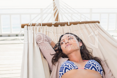 Pretty brunette relaxing on a hammock