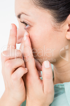 Brunette putting her contact lens