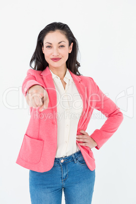 Smiling beautiful woman pointing with her finger Smiling beautiful woman pointing with her finger