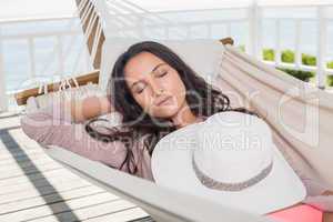 Pretty brunette relaxing on a hammock