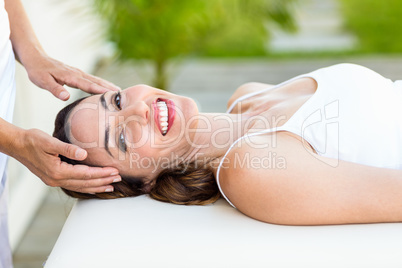 Calm woman receiving reiki treatment