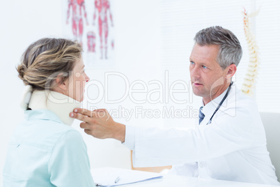 Doctor checking neck brace of his patient