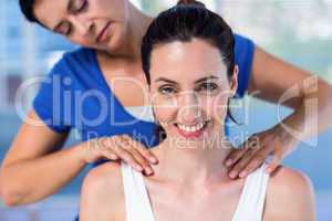 Therapist doing back massage to her patient