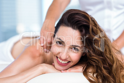 Smiling brunette getting back massage