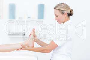 Physiotherapist doing foot massage