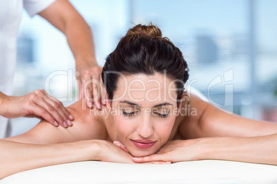 Smiling brunette getting back massage