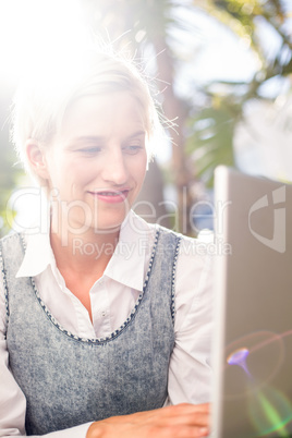 Pretty blonde woman using her laptop