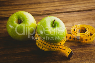 Green apples with measuring tape Green apples with measuring tape