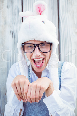 Pretty blonde woman smiling at the camera wearing funny hat