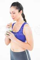 Attractive woman drinking green juice