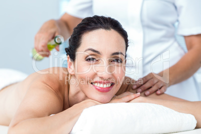 Smiling woman getting an aromatherapy treatment