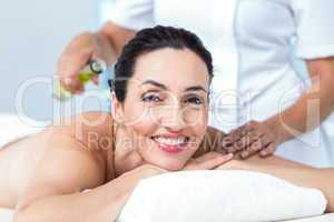 Smiling woman getting an aromatherapy treatment