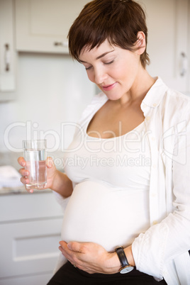 Pregnant woman having a glass of water