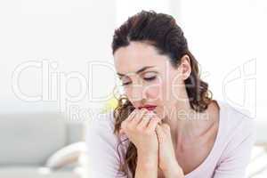 Sad brunette sitting on the couch