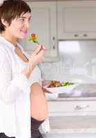 Pregnant woman eating a salad