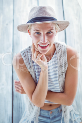 Pretty blonde woman wearing hat and smiling at camera