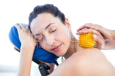 Woman having back massage with massage ball