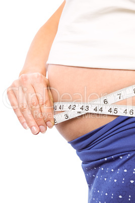 Pregnant woman measuring her bump