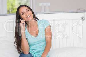 Happy brunette on the phone