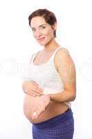 Pregnant woman showing body cream