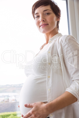 Pregnant woman holding her bump