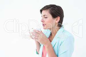Peaceful woman drinking cup of coffee