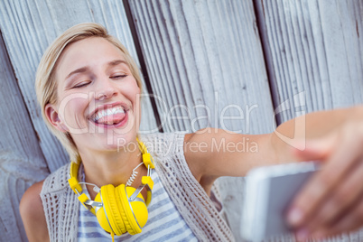 Pretty blonde woman taking selfie