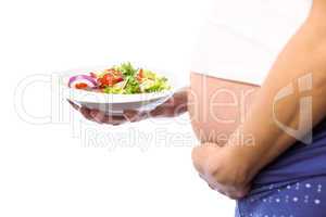 Pregnant woman eating a salad