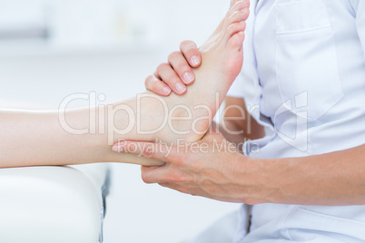 Physiotherapist doing foot massage