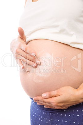 Pregnant woman with cream on bump