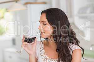 Pretty brunette having a glass of wine