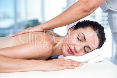 Smiling brunette getting back massage