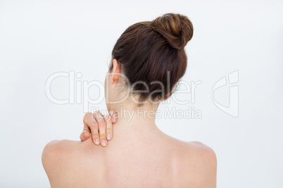 Woman touching her shoulder