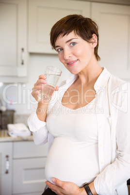 Pregnant woman having a glass of water