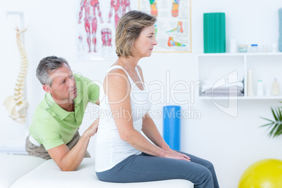 Doctor examining his patient back