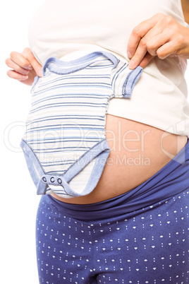 Pregnant woman holding baby clothes
