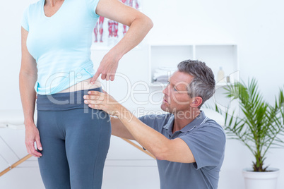 Physiotherapist examining his patient back