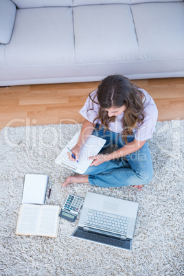 Woman calculating receipts writing on clipboard