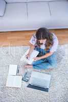 Woman calculating receipts writing on clipboard